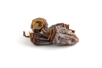 Dried persimmon on a white background. Fruits of dried persimmon close-up on a white background.