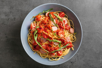 Delicious pasta with sauce and sausages on plate