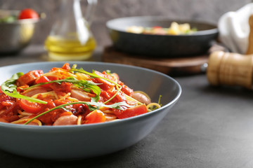 Delicious pasta with sauce and sausages on plate, closeup