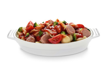 Delicious pasta with sausage and sauce in ceramic dish on white background