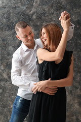 Beautiful couple dancing on grunge background