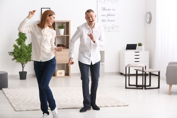 Beautiful couple dancing at home