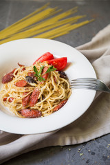 Spaghetti carbonara with sausages and ham