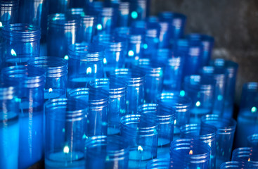 Blue plastic candles of a sanctuary with selective focus and copy space for text