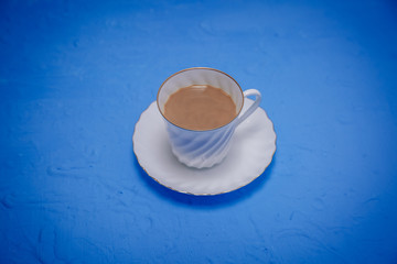 White coffee Cup and plate with blue background