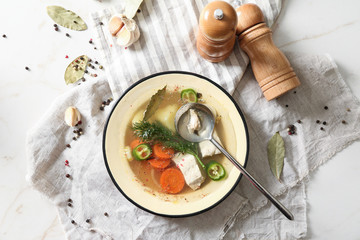 Bowl of tasty hot soup on light table