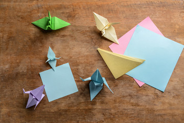 Origami cranes on wooden table