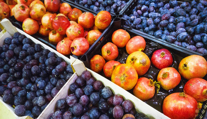 plums and pomegranates in the market