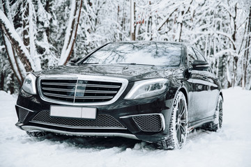 Car in the snow-covered forest