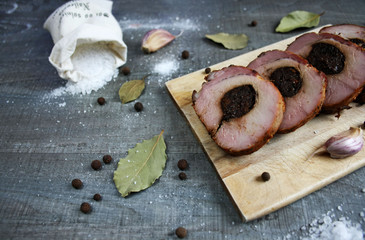 Baked pork chop with plum cut into slices surrounded by spices