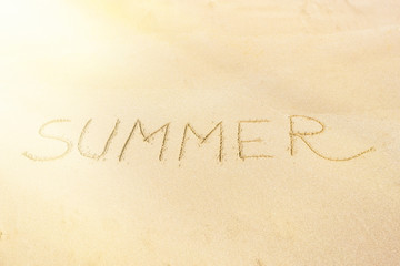 Fototapeta na wymiar Summer text on the sand , flare