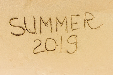 Fototapeta na wymiar Summer text on the sand