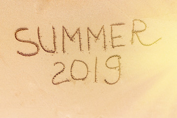 Fototapeta na wymiar Summer text on the sand , flare