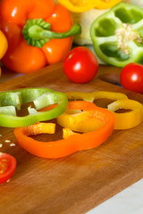 kitchen wooden Board with sliced juicy bright vegetables