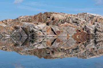 Fototapeta na wymiar Alpine mountains reflecting symmetrically in lake Lacs Noirs in summer
