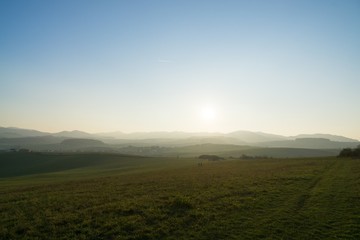 Fototapeta premium Misty morning on meadow with trees and views. Slovakia