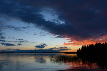 Fototapeta na wymiar colorful evening sunset reflecting over calm lake