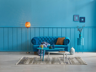 Blue living room, blue sofa and blue home decoration style with orange lamp.