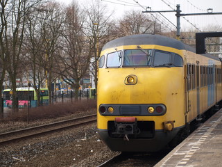 Naklejka premium Mat '64 train along the platform of Gouda station in the Netherlands.