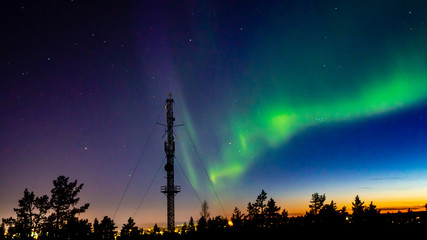 Northern lights scenery above Rovaniemi Finland with transmitter