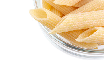 Raw feathers macaroni in bowl. Italian pasta close up, isolated on the white background
