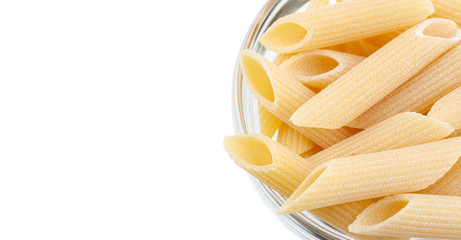 Raw feathers macaroni in bowl. Italian pasta close up, isolated on the white background