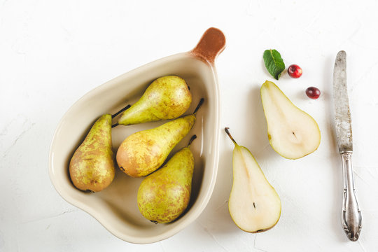 Fresh pears in a dish on a white background