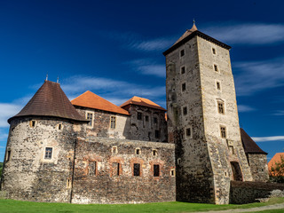 Medieval czech castle Svihov in western bohemia region with blurry blue sky backround