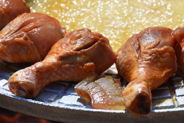 crispy chicken thighs  fried in oil and fried potatoes