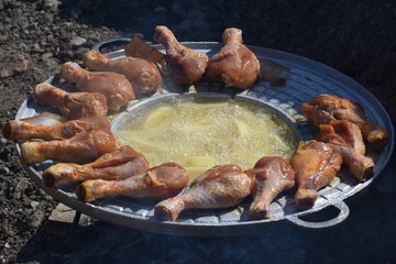crispy chicken thighs  fried in oil and fried potatoes