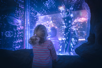 Surprised excited child looking with admiration lilac blue futuristic water view like portal into another reality  concept admiration amazement curiosity