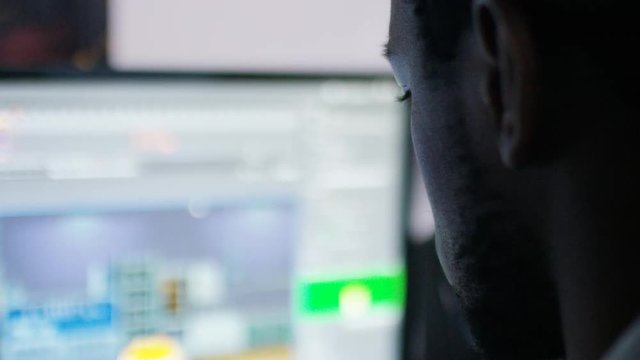 Profile shot of male computer animator looking over his work