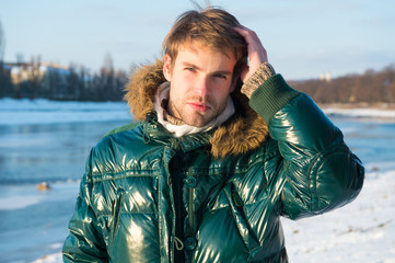 Happy winter holidays. Flu and cold. Winter fashion. Green warm coat. Warm clothes for cold season. Man traveling in winter, nature. Sexy man in warm clothes. Winter activities. Feeling warm