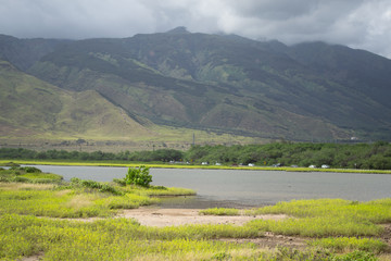 Stormy clouds on mountains over lake