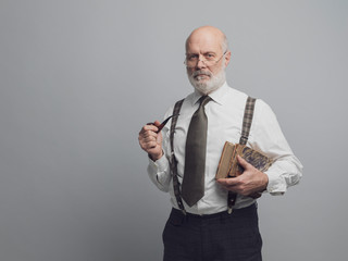 Confident academic professor posing with old books
