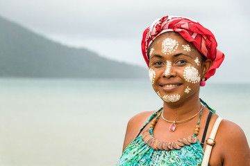 Portrait of a Malagasy woman with her face painted, Vezo-Sakalava tradition, Nosy Be, Madagascar. - obrazy, fototapety, plakaty