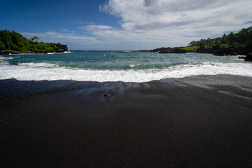 Black sand beach on road to Hana in Maui Hawaii