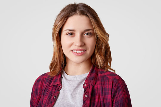 Portrait of happy European woman with dyed hair, being in good mood, rejoices day off, dressed in fashionable clothes, isolated over white background. Positive emotions and feelings concept.