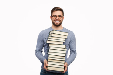 Smart handsome man with stack of books