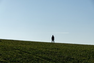 Fototapeta premium People walking on a meadow during sunset. Slovakia 