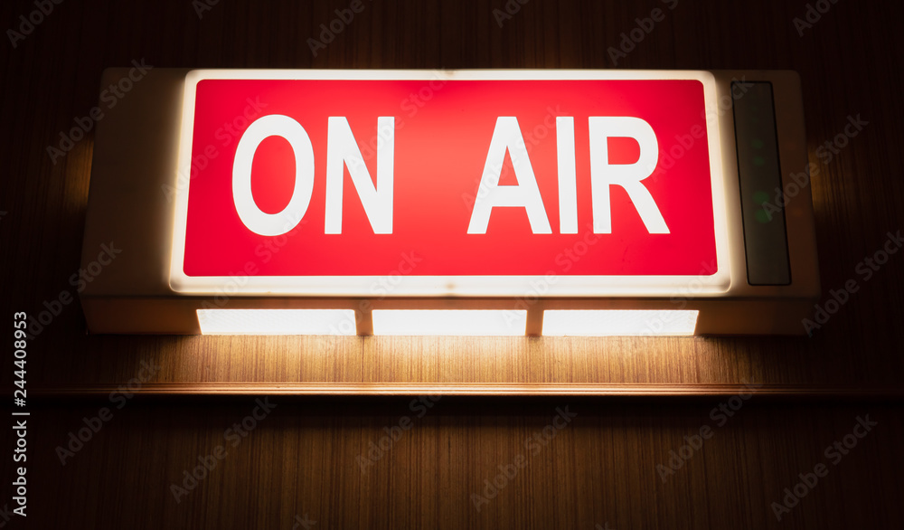 Wall mural on air sign icon glowing on the wooden wall of sound recording studios, live broadcast radio product