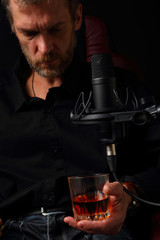 Musician in the recording Studio with a glass of whiskey