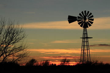 Windmill at Sunset with clouds and Silhouette.
