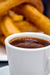Churros with chocolate served in a cup