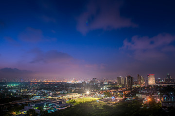 Beautiful aerial view of the city with football field in the night