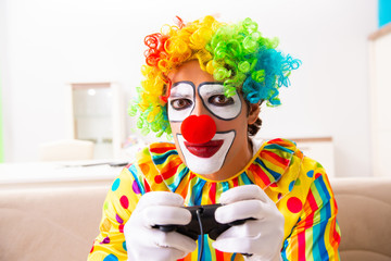 Male clown preparing for perfomance at home 