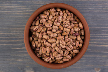 A plate of beans on wooden table background