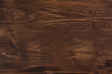 Brown scratched wooden cutting board. Wood texture