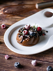 Chocolate cream mousse cake with fresh berries. delicious dessert.