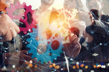 Business team connect pieces of gears. Teamwork, partnership and integration concept. Double...